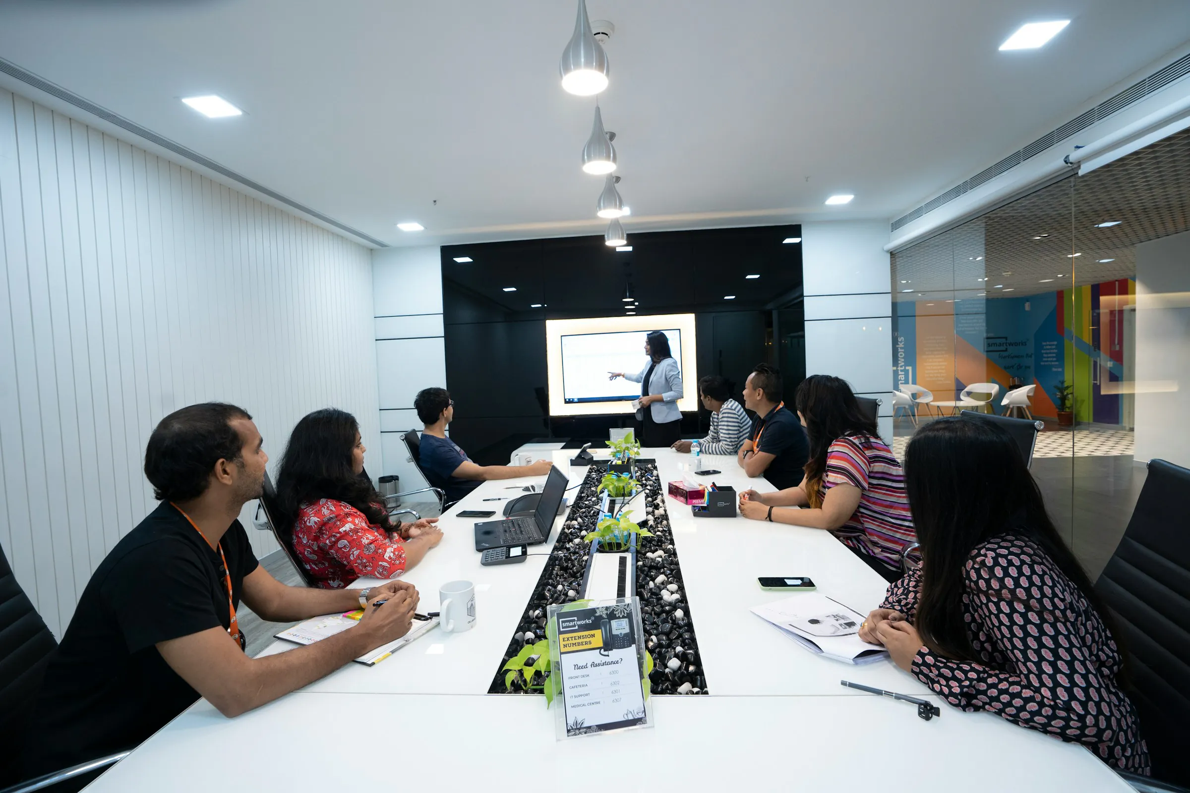 A Cyberdunes trainer leading a corporate session for professionals with laptops